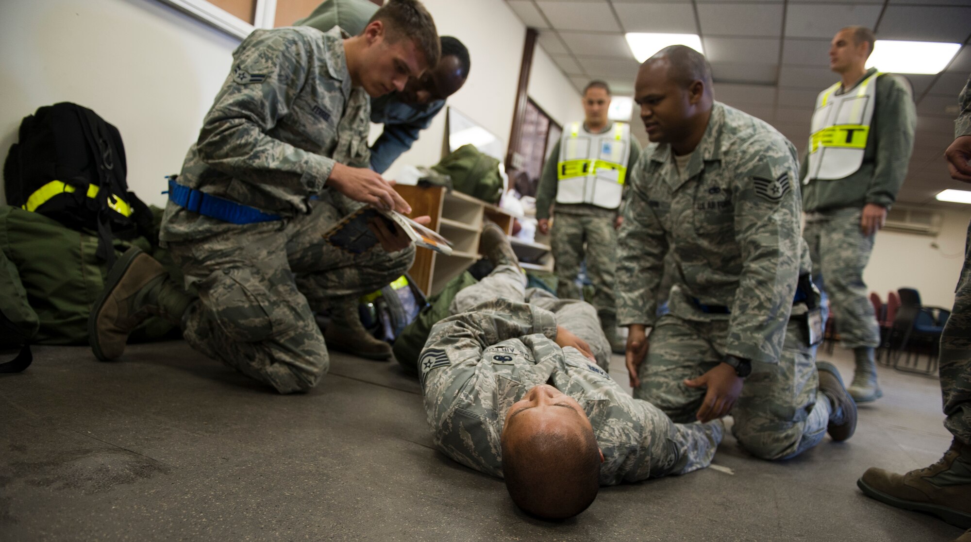 YOKOTA AIR BASE, Japan -- Airmen from the 374th Aircraft Maintenance Squadron perform self-aid and buddy care on a simulated victim during an operational readiness exercise at Yokota Air Base, Japan, Nov. 7, 2012. SABC is used to sustain a victim until further medical assistance can be given. (U.S. Air Force photo by Airman 1st Class Krystal M. Garrett)