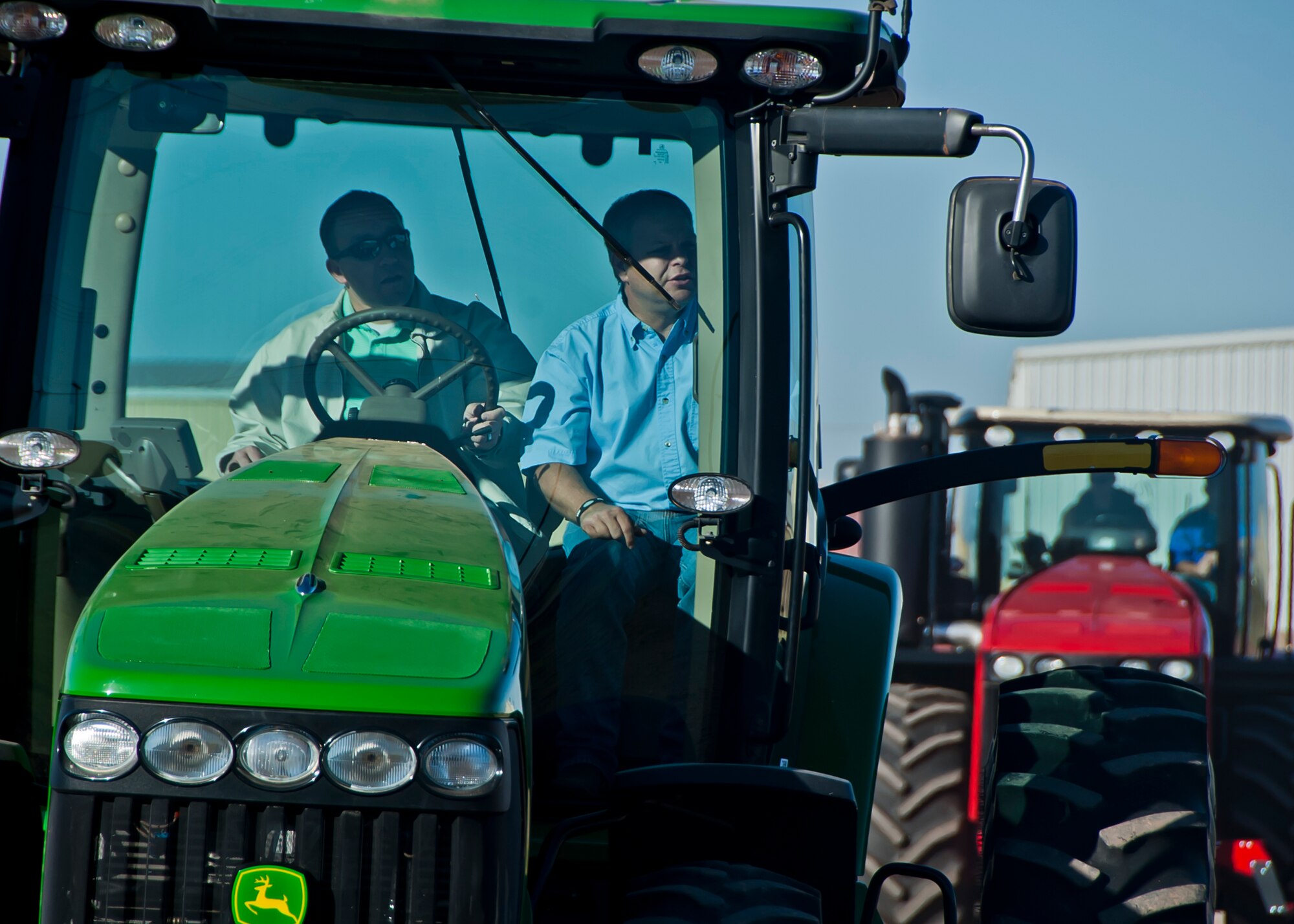 ALTUS, Okla., -- Lonnie Terbush, Western Equipment salesman, instructs Lt. Col. Derek Stuart, 58th Airlift Squadron director of operations, how to drive a tractor during Farm City Week, Nov. 7, 2012. Tractors and combines were available for Altus Air Force Base personnel and families to drive and learn about the tools local farmers use to plant crops. Farm City Week is held annually to highlight the importance of agriculture in the Altus and Jackson County economy and focuses on the partnership between the base and the local farming industry. (U.S. Air Force photo by Airman 1st Class Levin Boland / Released)