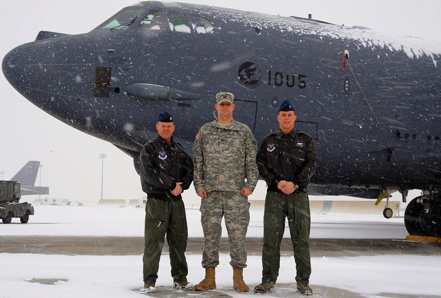 MINOT AIR FORCE BASE, N.D. -- Maj. David Golden and 1st Lt. Fleming Thompson, 23 Bomb Squadron, 5th Operations Group, and U.S. Army Capt. Joshua Payne, 5th Operations Support Squadron, have epitomized the 5th Bomb Wing commander's vision of mission ownership. These three officers orchestrated and executed the training for the 23d Bomb Squadron's tri-service multi-national JTAC CAS training exercise Operation COLD SNAP. Intrepid planning and execution resulted in 22 B-52H Stratofortress sorties and 8 WSTs directly supporting the Advanced Targeting Pod spin up for the wing. Utilizing ground assets, Golden, Payne, and Thompson created a realistic ground scenario requiring aircrew to locate and destroy enemy targets, track moving vehicles, and monitor enemy ground troop movements. This training resulted in an increase of the 5th BW's ATP crew numbers by 400 percent and saved the wing $2.6 million through shorter sorties and reduced sortie requirements. Their determined work produced a far more combat capable crew force for the 5th BW, capable of answering the nations call at a moments notice.