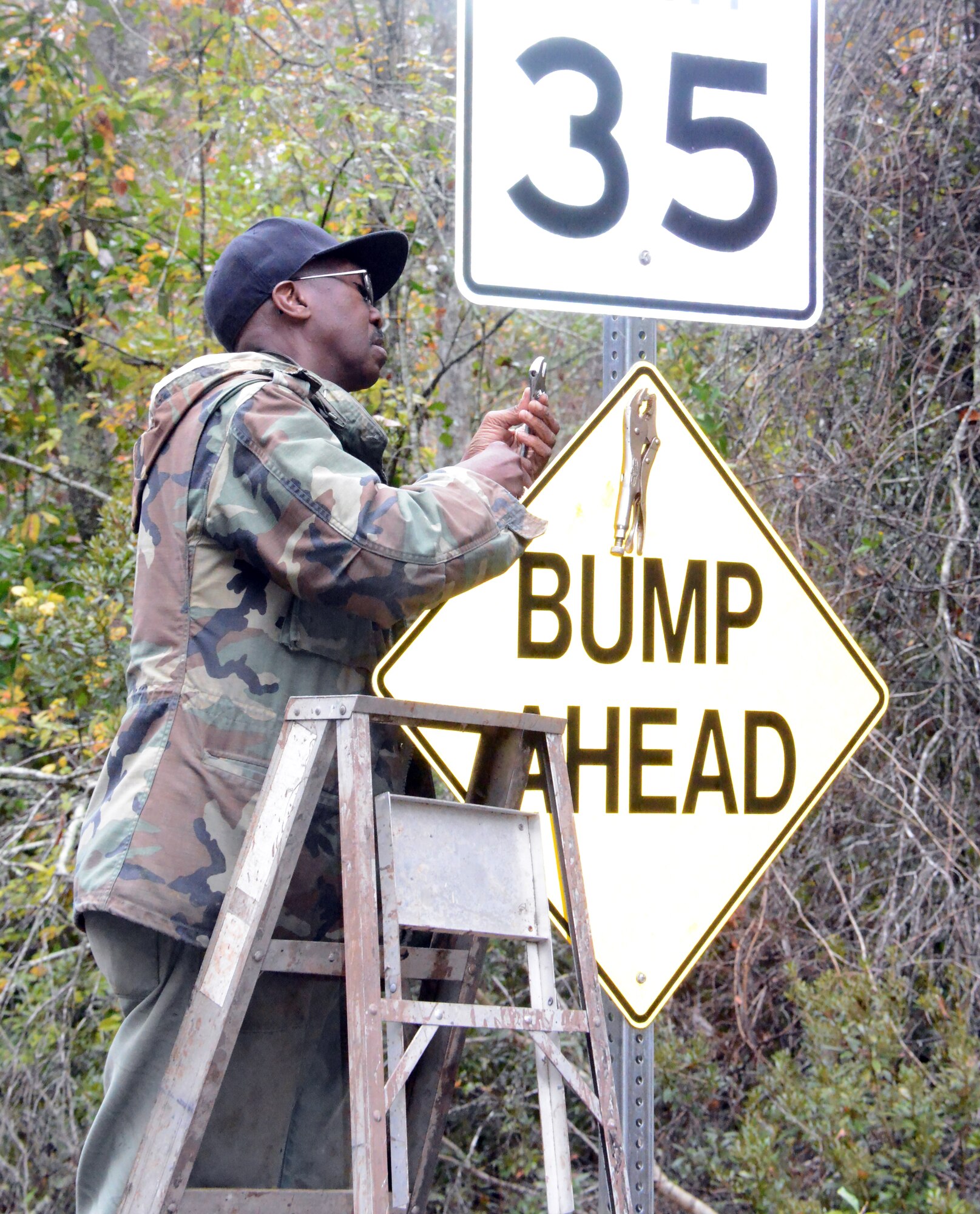 Ronald King, 78th Civil Engineer Squadron Horizontal Shop, removes a caution sign which will no longer be needed following the construction. (U. S. Air Force photo/Ed Aspera)