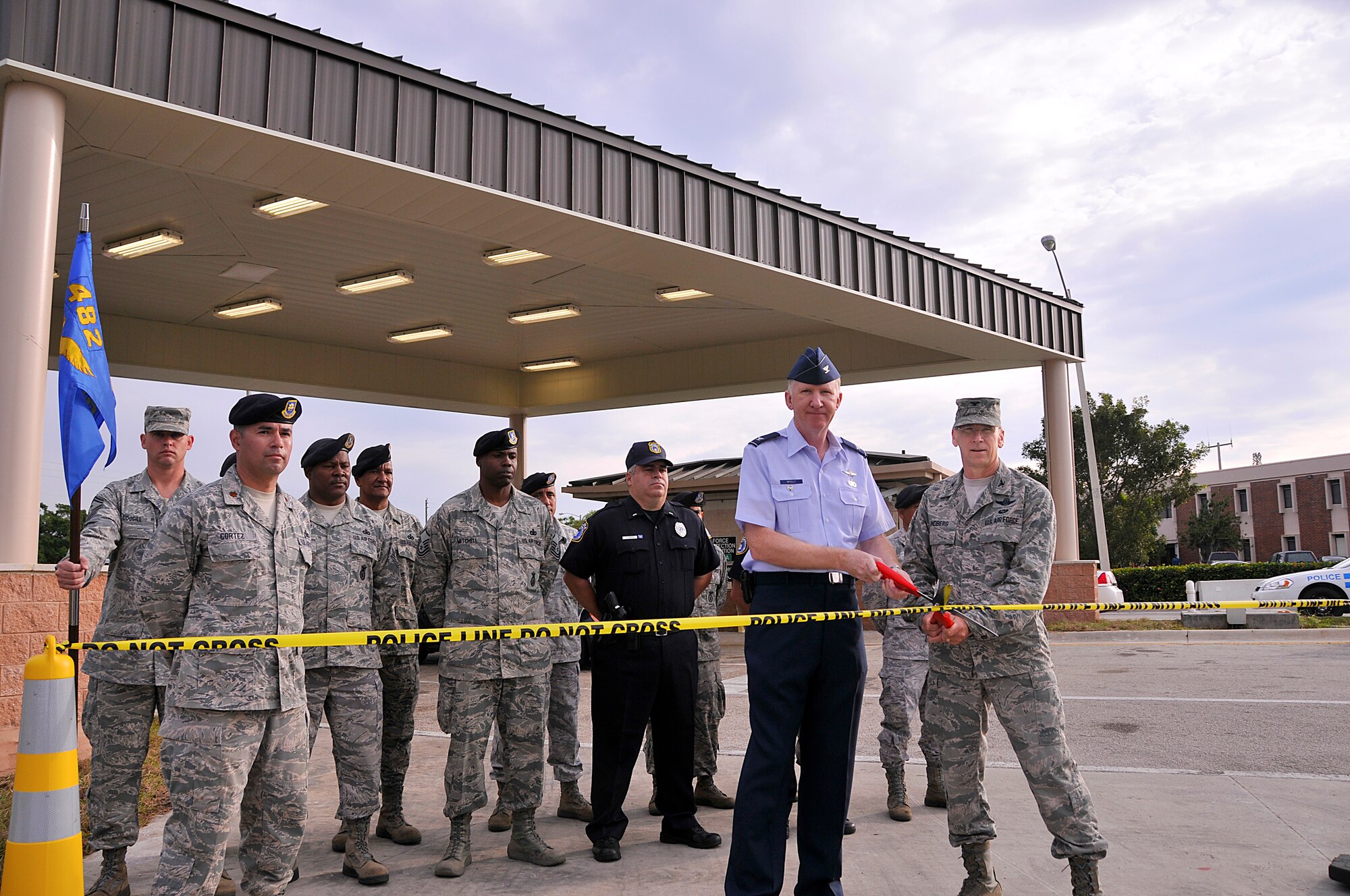 Col. Donald R. Lindberg, Commander, 482nd Fighter Wing and Col. Michael McCully,Air Force Reserve Command, Director of Installations and Mission Support cut the theoretical ribbon, police tape, in honor of the new canopy erected at the Westover gate, Nov.5. (U.S. Air Force photo/ Staff Sgt. Lou Burton, 482nd Fighter Wing Public Affairs)