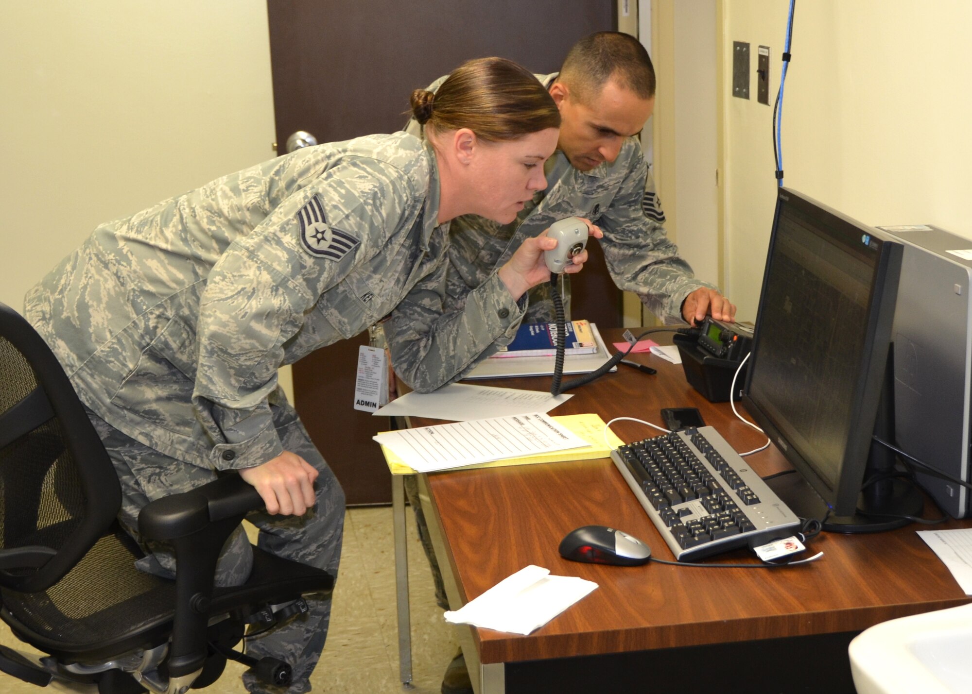Staff Sgt. Cassandra Key and Master Sgt. Thelmo Frias, 81st Medical Support Squadron, provide information to the 81st Medical Group response teams during the  major accident response exercise Oct. 26, 2012, at Keesler Air Force Base, Miss.  (U.S. Air Force photo by Steve Pivnick)