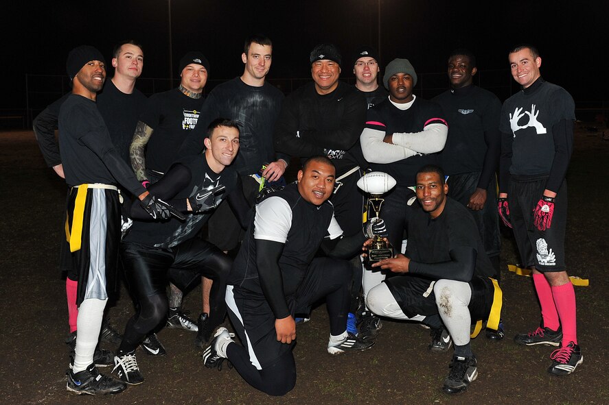 The 55th Intelligence Support Squadron flag football team poses for a photo after their win over U.S. Strategic Command on Offutt Air Force Base, Neb., Nov. 5. The 55th ISS flag football players won double elimination decision over USSTRATCOM. (U.S. Air Force photo by Charles Haymond/Released)