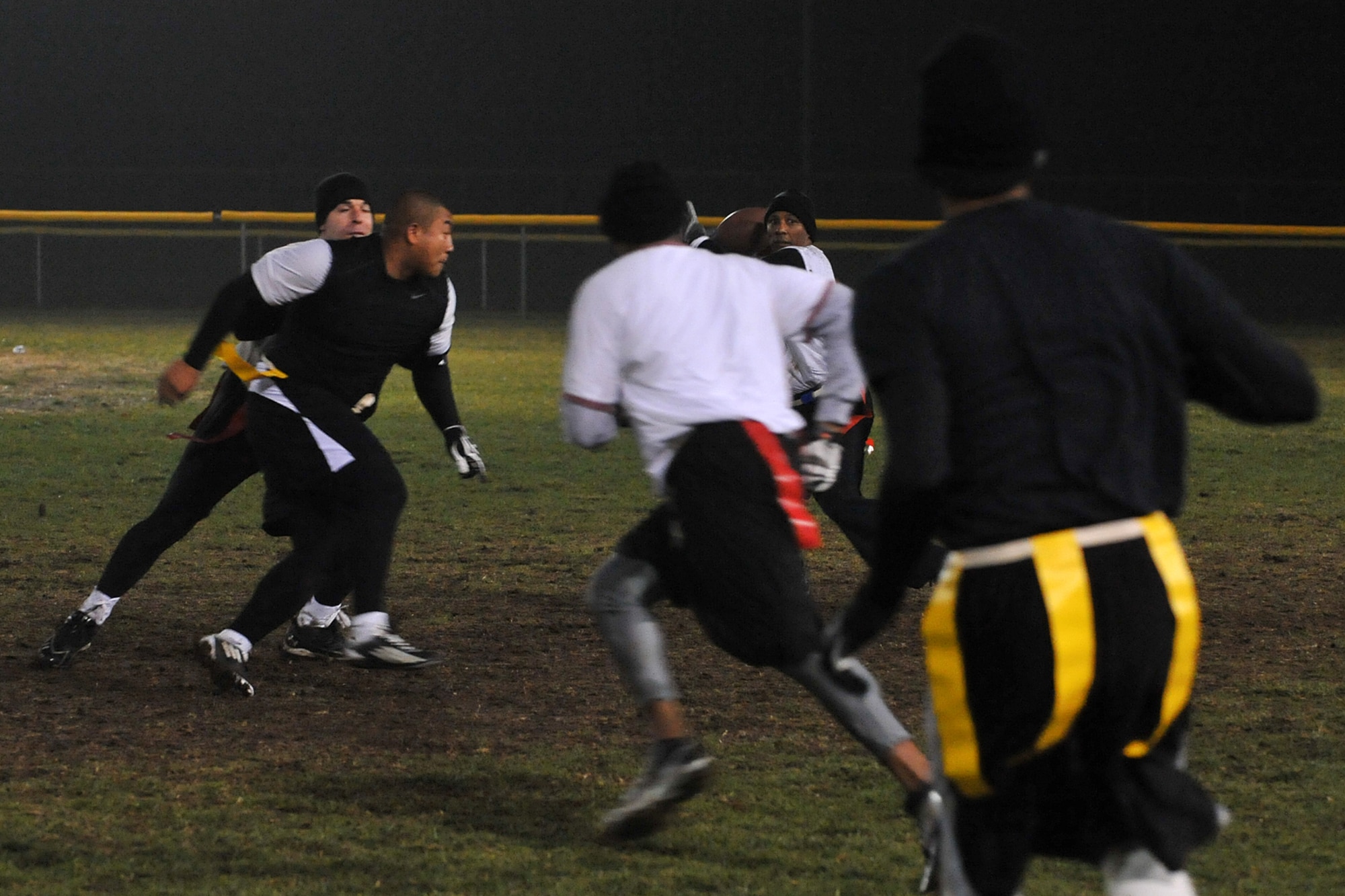 U.S. Air Force Maj. Corey Edmonds, with the U.S. Strategic Command, throws a football down the field during the intramural flag football game between 55th Intelligence Support Squadron and USSTRATCOM on Offutt Air Force Base, Neb., Nov. 5. USSTRATCOM conducts global operations in coordination with other combatant commands, services and appropriate U.S. government agencies to deter and detect strategic attacks against the U.S. and its allies. (U.S. Air Force photo by Charles Haymond/Released)