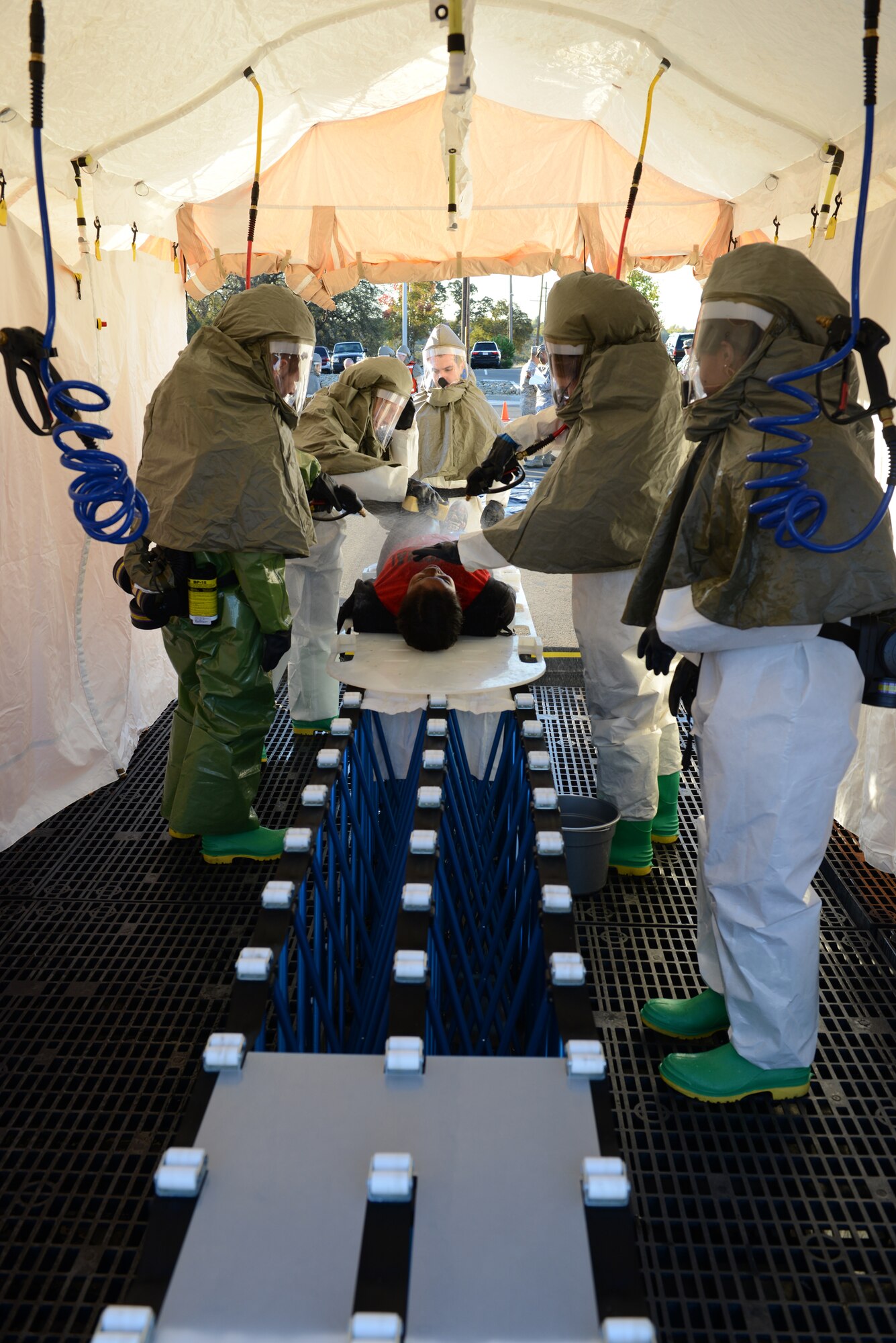9th Medical Group personnel decontaminate a simulated infected Airman during a disease containment emergency management exercise Nov. 7, 2012 at Beale Air Force Base, Calif. The exercise measured the base and specifically the 9th MDG response to a biological emergency. (U.S. Air Force photo by Mr. John Schwab/ Released)