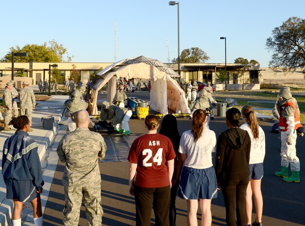9th Medical Group personnel set up a portable decontamination shelter as simulated infected Airman wait for processing during a disease containment emergency management exercise Nov. 7, 2012 at Beale Air Force Base, Calif. The exercise measured the base and specifically the 9th MDG response to a biological emergency. (U.S. Air Force photo by Mr. John Schwab/ Released)