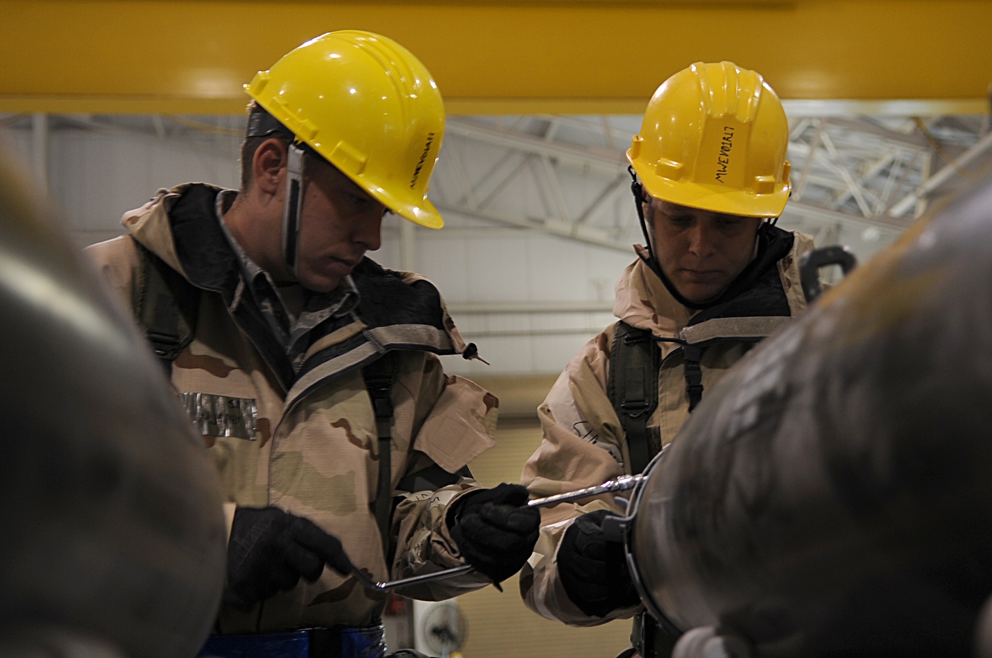 The 366th Equipment Maintenance Squadron’s Senior Airman Brian Murphy, and Staff Sgt. Matthew Holden, conventional maintenance crew chiefs, work on a Joint Direct Attack Munition during the second phase of an Operational Readiness Exercise Nov. 7, 2012 at Mountain Home Air Force Base, Idaho.  Airmen like Murphy and Holden are responsible for producing aircraft countermeasures and munitions, and can also build an average of 24-42 bombs per day. (U.S. Air Force Photo/Released) 