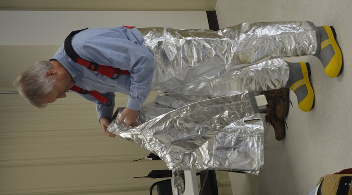 Honorary Commander Jim Geffert dons a proximity suit during the Quarterly Honorary Commanders Tour Nov. 5, 2012 at the Fire Department training area at Joint Base Charleston – Air Base, S.C. The tour educates the Honorary Commanders on the different mission areas of Joint Base Charleston. Geffert is the Honorary Commander assigned to Col. Al Miller, 437th Airlift Wing vice commander. (U.S. Air Force photo/Trisha Gallaway)