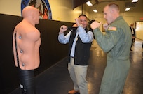 Airman 1st Class Chuck Benton, 628th Security Forces Squadron Raven, teaches Honorary Commander James Warner tactical maneuvers on a dummy Nov. 5, 2012, during the Honorary Commanders Quarterly Tour at Joint Base Charleston – Air Base, S.C. The tour educates the Honorary Commanders on the different mission areas of Joint Base Charleston. Warner is the Honorary Commander assigned to Navy Capt. Thomas Bailey, Joint Base Charleston deputy commander. (U.S. Air Force photo/Trisha Gallaway)
