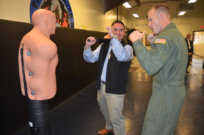 Airman 1st Class Chuck Benton, 628th Security Forces Squadron Raven, teaches Honorary Commander James Warner tactical maneuvers on a dummy Nov. 5, 2012, during the Honorary Commanders Quarterly Tour at Joint Base Charleston – Air Base, S.C. The tour educates the Honorary Commanders on the different mission areas of Joint Base Charleston. Warner is the Honorary Commander assigned to Navy Capt. Thomas Bailey, Joint Base Charleston deputy commander. (U.S. Air Force photo/Trisha Gallaway)
