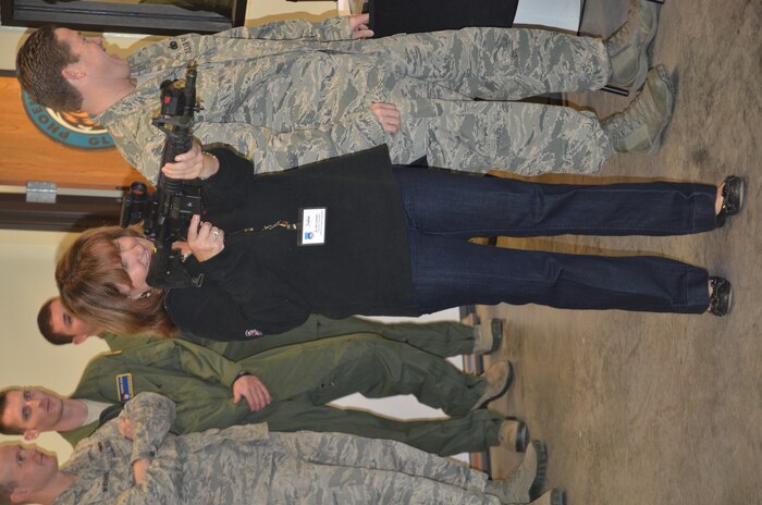 Honorary Commander Julie Gerthoffer takes aim at a target using the Laser Marksmanship Training System during a visit to the Combat Arms Training and Maintenance unit, Nov. 5, 2012, as part of the Quarterly Honorary Commanders tour at Joint Base Charleston – Air Base, S.C. The tour educates the Honorary Commanders on the different mission areas of Joint Base Charleston. Gerthoffer is the Honorary Commander assigned to Lt. Col. Danny Davis, 628th Force Support Squadron commander. (U.S. Air Force photo/Trisha Gallaway)