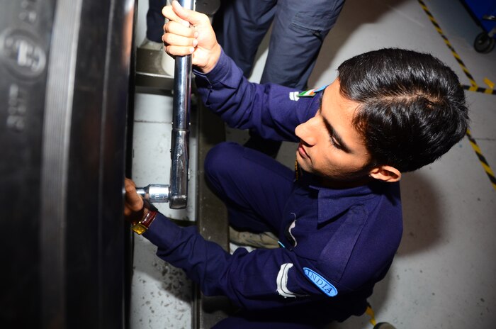 A member of the Indian air force unbolts a tire during a simulated tire change on a C-17 Globemaster III Nov. 2, at Joint Base Charleston, S.C. The IAF is sending about 100 of their airmen here for training on various aspects of the C-17 in preparation of standing up their first ever C-17 squadron in India. (U.S. Air Force photo/Senior Airman William O'Brien)