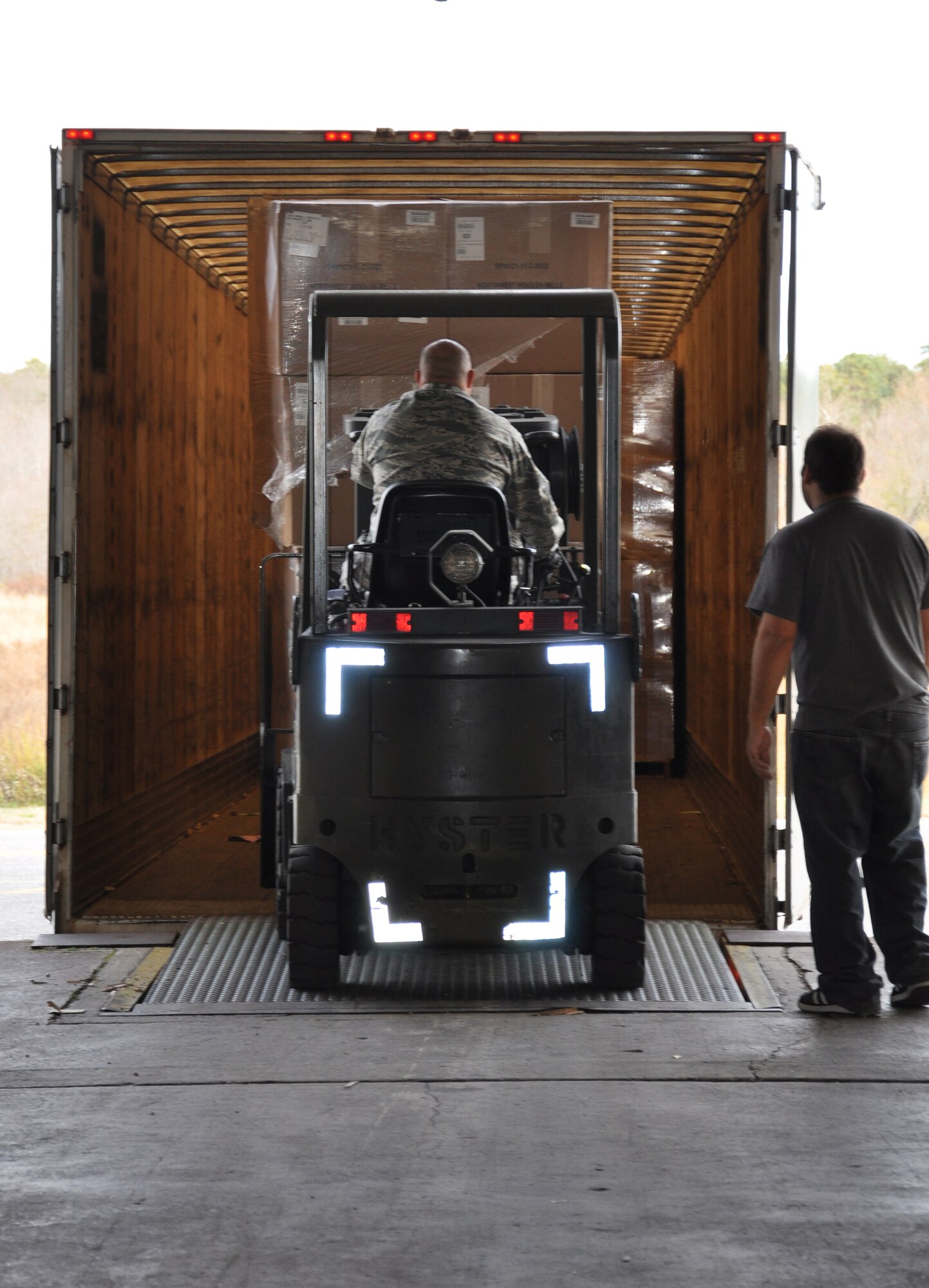 Master Sgt. Sam Charles, 305th Aerial Port Squadron traffic management craftsman, drives a fork lift carrying boxes of blankets onto a waiting semi truck Nov. 6. Airmen and civilians with the 305th APS worked to transport more than 750 boxes containing 7,800 blankets intended for the vicitims of Hurricane Sandy. (U.S. Air Force photo by 2nd Lt. Alexis McGee/Released)