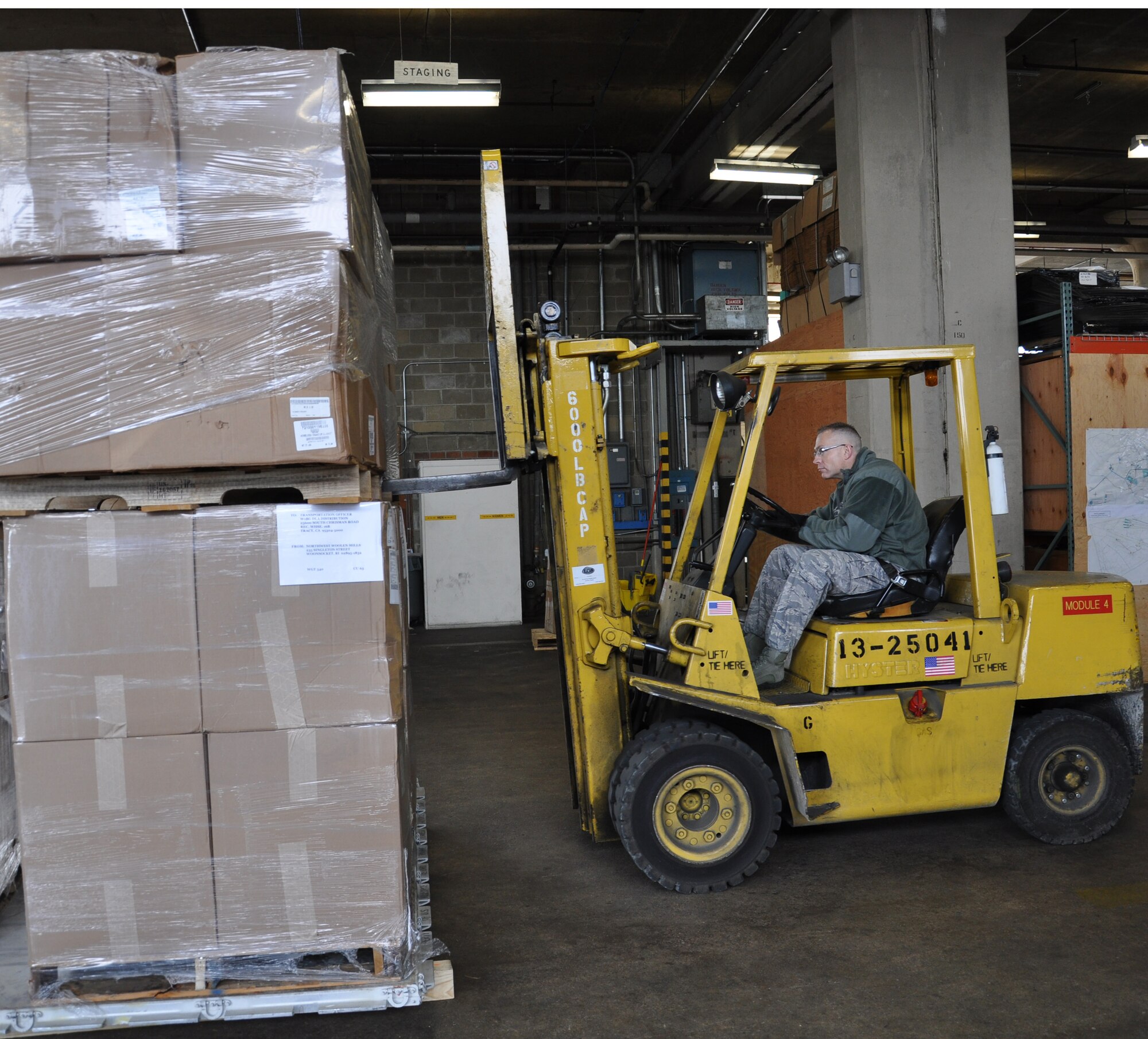 Tech. Sgt. Terry Johnson, 305th Aerial Port Squadron traffic management craftsman uses a forklift to position boxes of blankets Nov. 6. Airmen and civilians with the 305th APS served as a critical link in a mass blanket delivery movement that began at Travis Air Force Base, Calif. Johnson calls Gansvord, N.Y., home. (U.S. Air Force photo by 2nd Lt. Alexis McGee/Released)