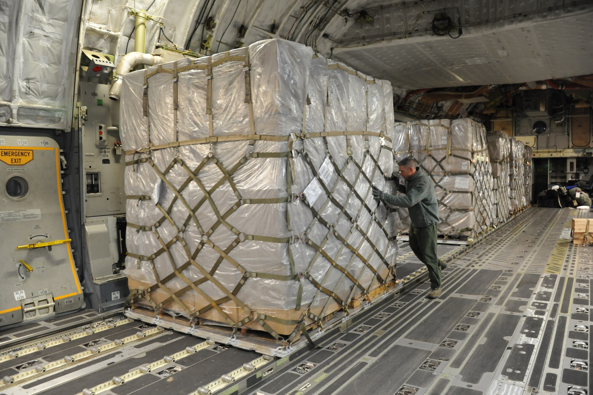 Airmen from the 445th Air Wing out of Wright Patterson Air Force Base, Ohio, work with the 305th Air Mobility Wing, 305th Aerial Port Squadron, at Joint Base McGuire-Dix-Lakehurst, N.J., move pallets of blankets onto a K-loader Nov. 6, 2012. The more than 21,000 pounds of blankets were shipped from Travis AFB, Calif., via C-17 Globemaster III for distribution by the Federal Emergency Management Agency for Hurricane Sandy relief efforts. (U.S. Air Force photo by 2nd Lt. David J. Murphy/Released)