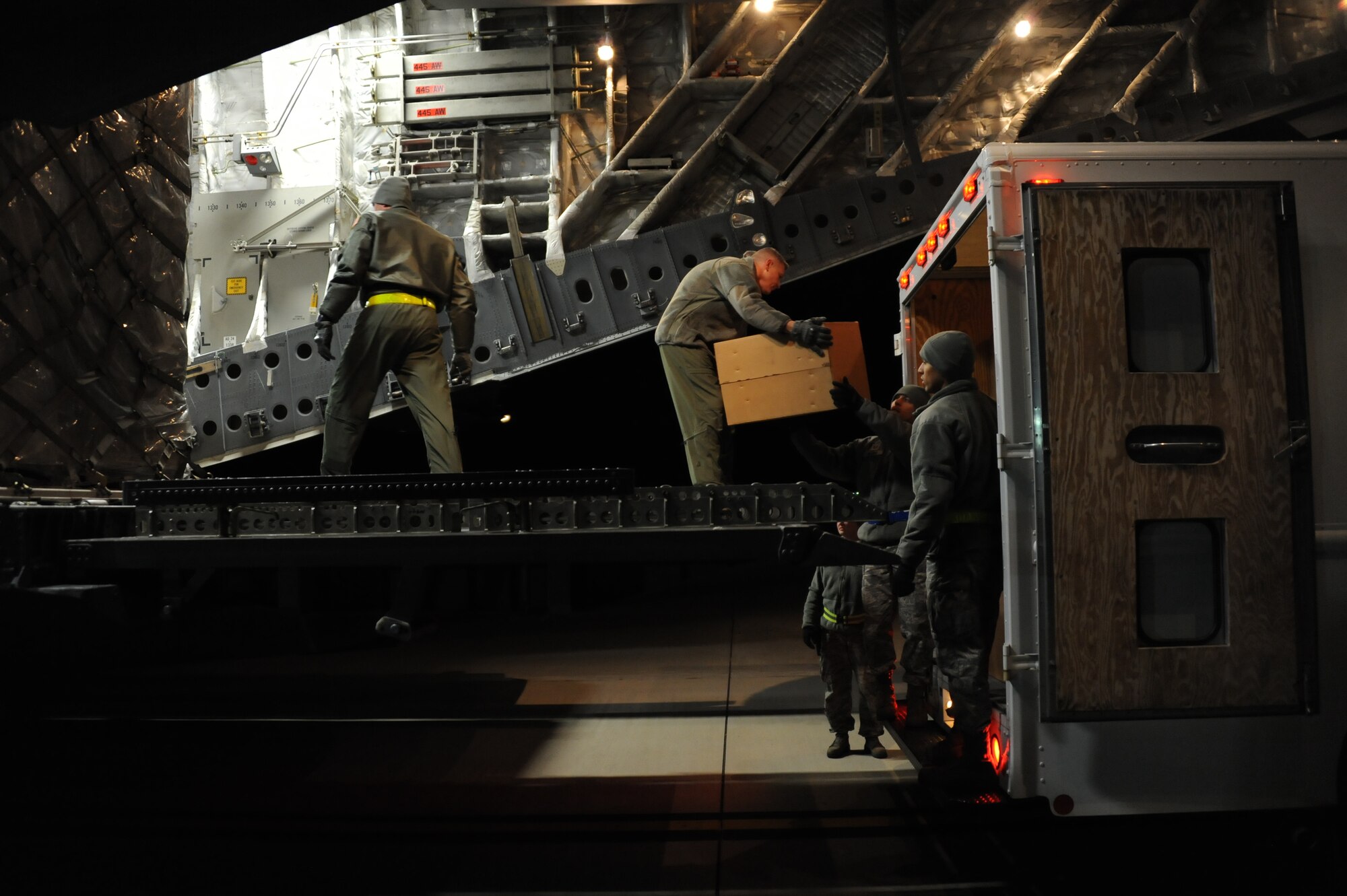 Airmen from the 445th Air Wing out of Wright Patterson Air Force Base, Ohio, work with the 305th Air Mobility Wing, 305th Aerial Port Squadron, at Joint Base McGuire-Dix-Lakehurst, N.J., to deliver more than 21,000 pounds of blankets Nov. 6, 2012. The blankets were shipped from Travis AFB, Calif., via C-17 Globemaster III for distribution by the Federal Emergency Management Agency for Hurricane Sandy relief efforts. (U.S. Air Force photo by 2nd Lt. David J. Murphy/Released)
