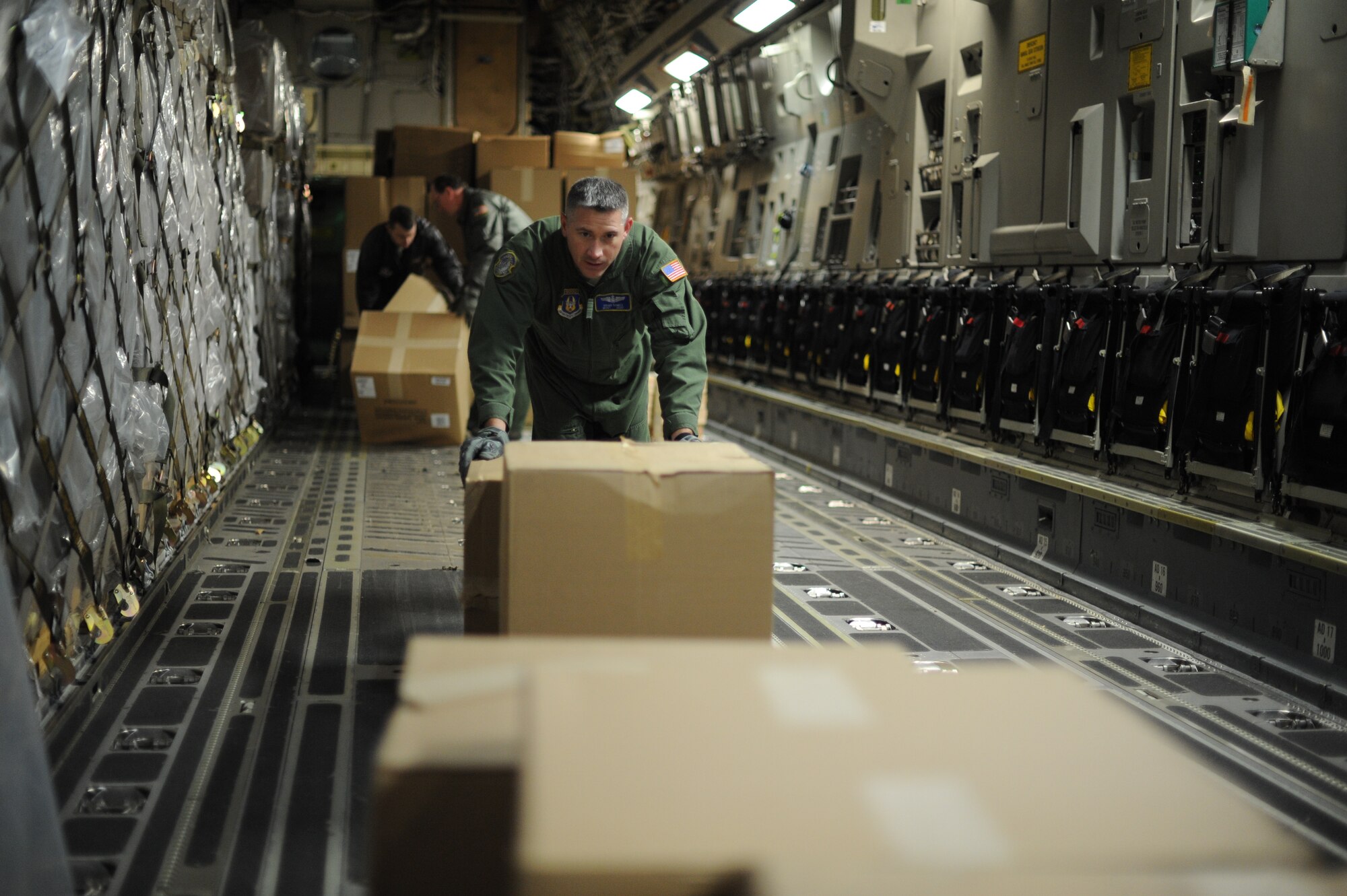 Master Sgt. James Ownes, 445th Air Wing loadmanster, and other Airmen from Wright Patterson Air Force Base, Ohio, work with the 305th Air Mobility Wing, 305th Aerial Port Squadron, at Joint Base McGuire-Dix-Lakehurst, N.J., to deliver more than 21,000 pounds of blankets Nov. 6, 2012. The blankets were shipped from Travis AFB, Calif., via C-17 Globemaster III for distribution by the Federal Emergency Management Agency for Hurricane Sandy relief efforts. (U.S. Air Force photo by 2nd Lt. David J. Murphy/Released)