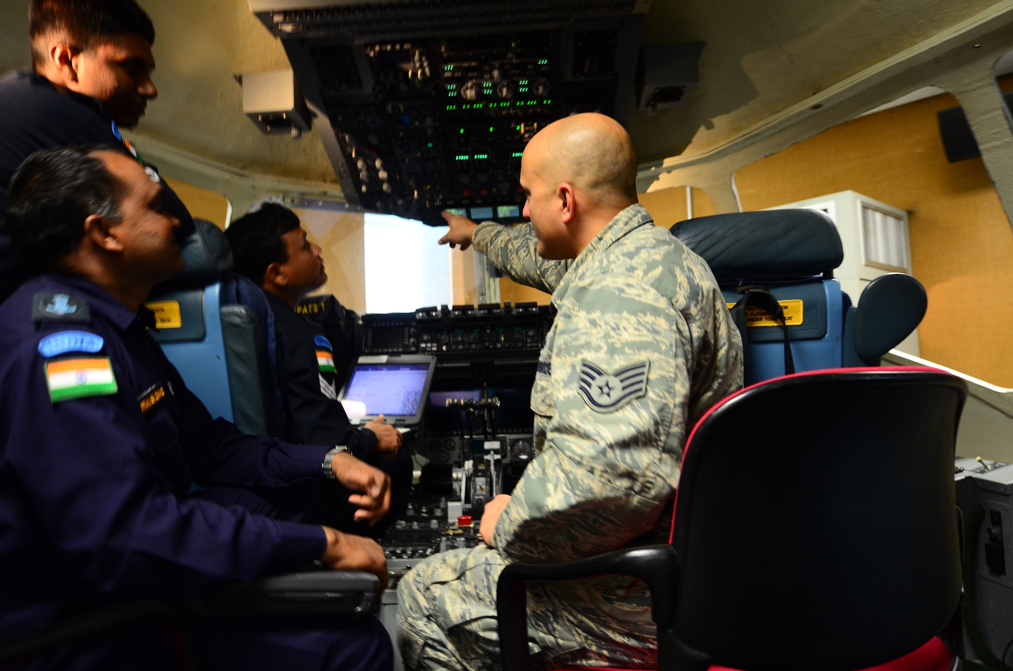 Staff Sgt. Jeremy Foster, 373rd Training Squadron Detachment 5 electronic environmental electrical environmental instructor, explains different aspects of the C-17 Globemaster III to students from the Indian air force during a hands-on simulator training Nov. 1, at Joint Base Charleston, S.C. The IAF plans to send about 100 students to the 373rd to learn various maintenance aspects of the C-17 in preparation of the IAF’s first C-17 squadron. (U.S. Air Force photo/Senior Airman William O’Brien)
