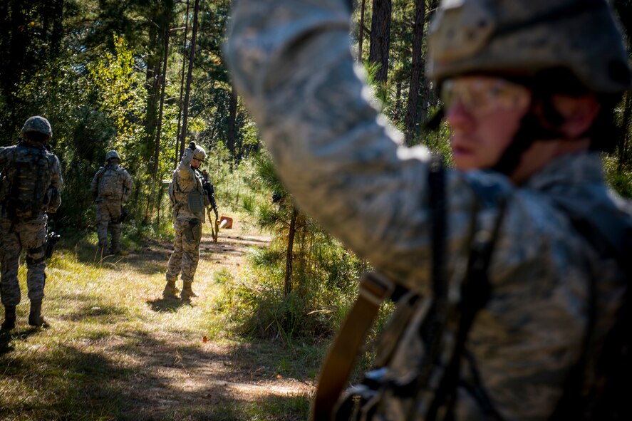 Airmen from the 823d Base Defense Squadron signal halt while conducting improvised explosive device lane training at Moody Air Force Base, Ga., Nov. 1, 2012. The Airmen maintained situational awareness throughout the training to combat unforeseen IED threats they may face downrange. (U.S. Air Force photo by Staff Sgt. Jamal D. Sutter/Released)