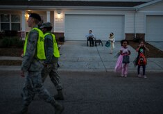 Airman 1st Class Alan Barker, 628th Security Forces Squadron entry patroller, and A1C Danetta Woods, 437th Maintenance Squadron avionics technician, perform pumpkin patrol duty Oct. 31, 2012 at Joint Base Charleston – Air Base housing. Several individuals from the base volunteered to patrol on-base housing at both the Air Base and Weapons Station to ensure children and their families were safe while trick or treating. (U.S. Air Force photo/ Senior Airman Dennis Sloan) 
