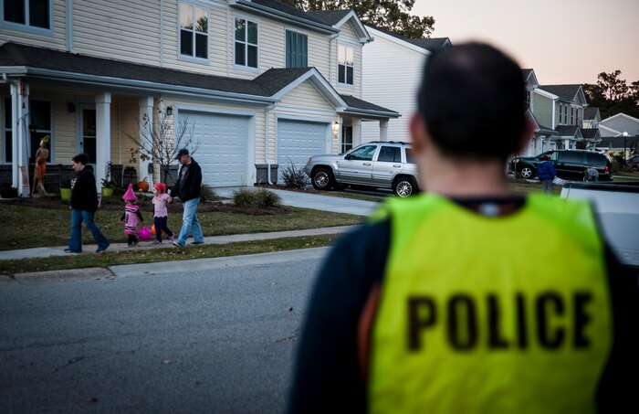 Staff Sgt. Benjamin Stewart, 628th Civil Engineer Squadron Explosive Ordinance Disposal technician, performs pumpkin patrol duty Oct. 31, 2012 at Joint Base Charleston – Air Base housing. Several individuals from the base volunteered to patrol on-base housing at both the Air Base and Weapons Station to ensure children and their families were safe while trick or treating. (U.S. Air Force photo/ Senior Airman Dennis Sloan)