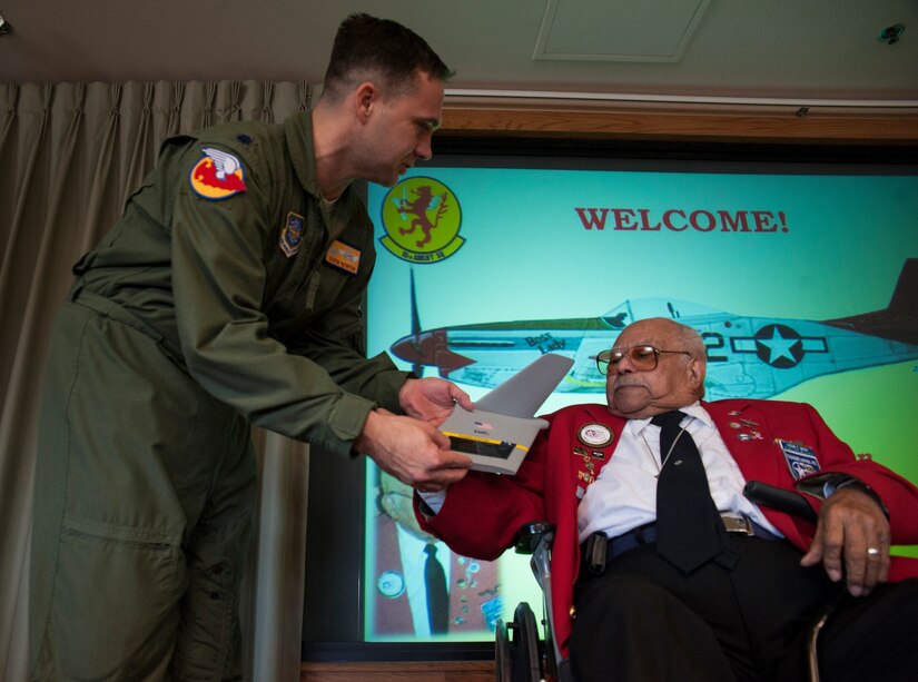 Lt. Col. Stew Newton, 16th Airlift Squadron commander, gives Tuskegee Airman, retired Lt. Col. Hiram Mann, a C-17 tail during his visit to the 16th Airlift Squadron Nov. 2, 2012 at Joint Base Charleston - Air Base, S.C. Entering the Army Air Corps as a pre-aviation student in 1942, Mann was assigned to the 100th Fighter Squadron of the 332nd Fighter Group, the Red Tail Angels, in Italy. During his career, Mann flew the P-40 "Warhawk" and the P-47 "Thunderbolt" fighter-type aircraft, and co-piloted the B-25 "Billy Mitchell" bomber, the C-47 "Gooney-bird" and the C-45 "Expediter” cargo planes. (U.S. Air Force photo/Airman 1st Class Ashlee Galloway)