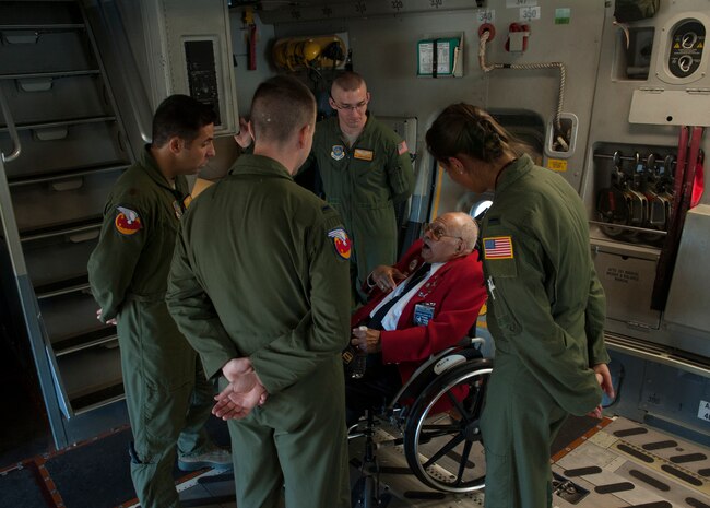 Tuskegee Airman, retired Lt. Col. Hiram Mann, speaks with Airmen while he tours a C-17 Globemaster III Nov. 2, 2012, at Joint Base Charleston - Air Base, S.C. Entering the Army Air Corps as a pre-aviation student in 1942, Mann was assigned to the 100th Fighter Squadron of the 332nd Fighter Group, the Red Tail Angels, in Italy. During his career, Mann flew the P-40 "Warhawk" and the P-47 "Thunderbolt" fighter-type aircraft, and co-piloted the B-25 "Billy Mitchell" bomber, the C-47 "Gooney-bird" and the C-45 "Expediter” cargo planes. (U.S. Air Force photo/Airman 1st Class Ashlee Galloway)