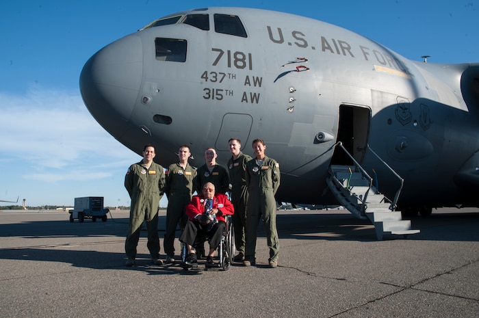 Tuskegee Airman, retired Lt. Col. Hiram Mann, poses with Airmen in front of a C-17 Globemaster III Nov. 2, 2012 at Joint Base Charleston - Air Base, S.C. Entering the Army Air Corps as a pre-aviation student in 1942, Mann was assigned to the 100th Fighter Squadron of the 332nd Fighter Group, the Red Tail Angels, in Italy. During his career, Mann flew the P-40 "Warhawk" and the P-47 "Thunderbolt" fighter-type aircraft, and co-piloted the B-25 "Billy Mitchell" bomber, the C-47 "Gooney-bird" and the C-45 "Expediter” cargo planes. (U.S. Air Force photo/Airman 1st Class Ashlee Galloway)