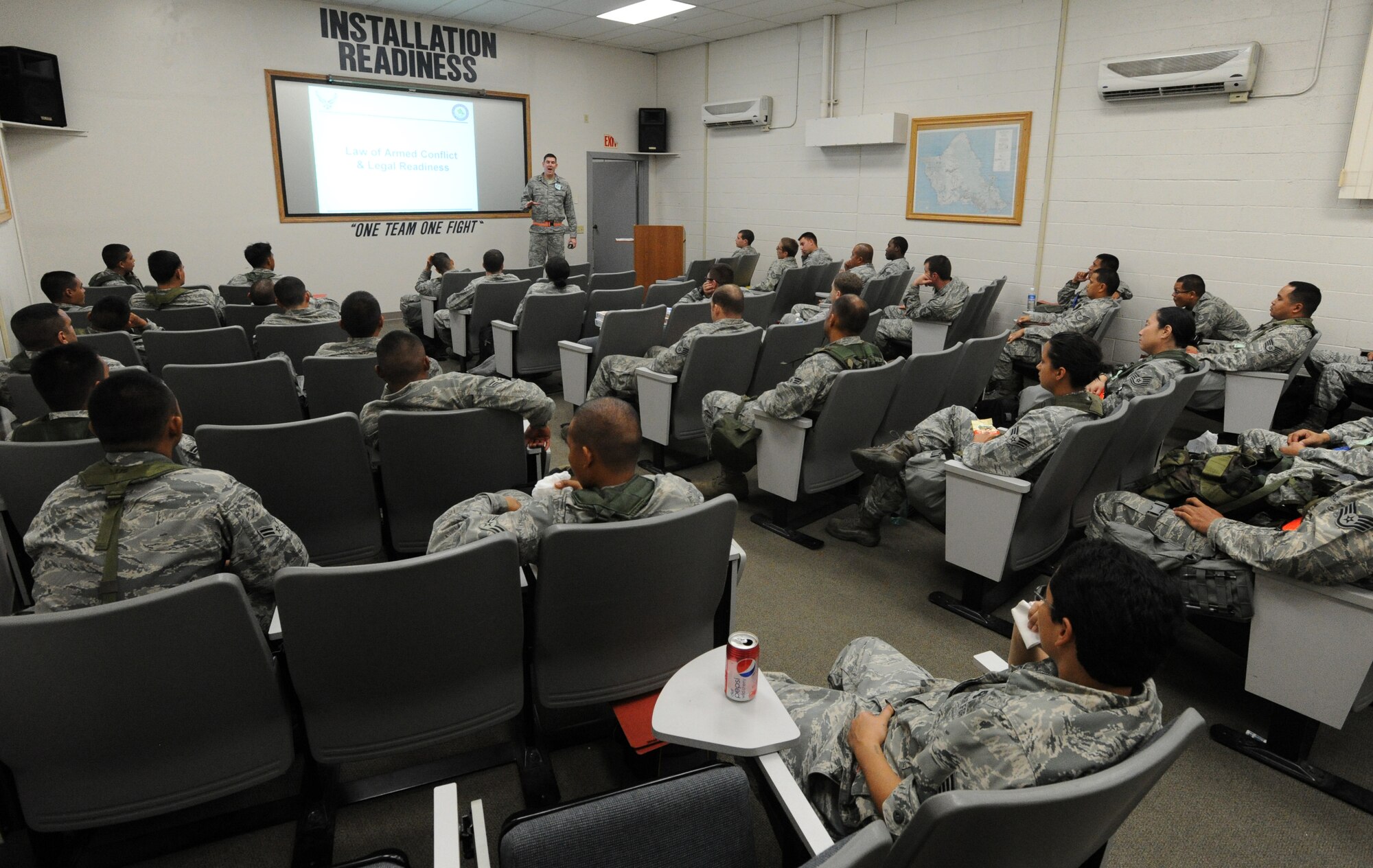 Airmen from the Hawaii Air National Guard receive a brief from the 15th Wing legal office after processing through a personnel deployment function line Nov. 7 during an exercise at Joint Base Pearl Harbor-Hickam, Hawaii. The PDF line tests the ability of Airmen to be medically, legally, administratively, spiritually, and financially ready to deploy, as well as the functionality of the processes in place with which to deploy them. (U.S. Air Force photo by Staff Sgt. Nathan Allen)