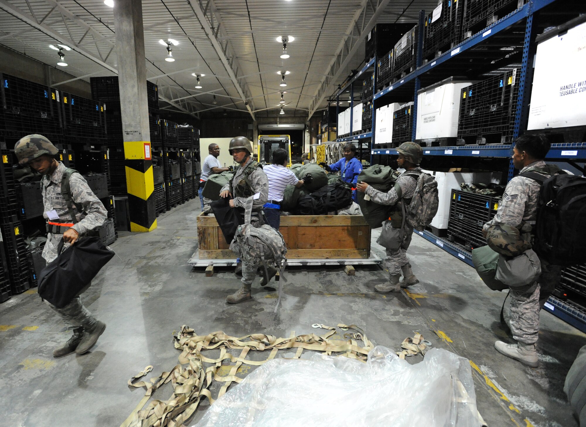 Airmen from the Hawaii Air National Guard submit their bags to be palletized before processing through a personnel deployment function line Nov. 7 during an exercise at Joint Base Pearl Harbor-Hickam, Hawaii. The PDF line tests the ability of Airmen to be medically, legally, administratively, spiritually, and financially ready to deploy, as well as the functionality of the processes in place with which to deploy them. (U.S. Air Force photo by Staff Sgt. Nathan Allen)