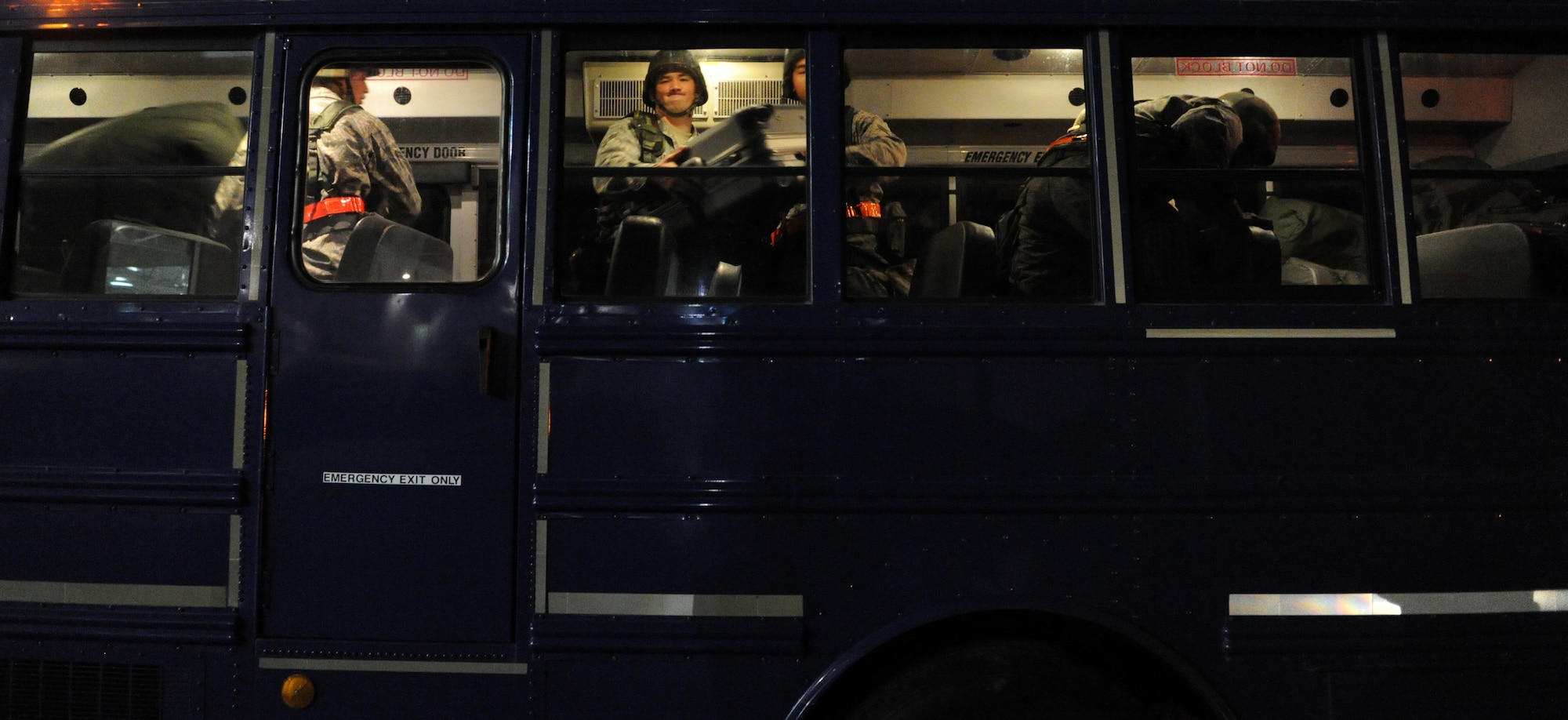 Airmen from the Hawaii Air National Guard work together to offload luggage from a bus before processing through a personnel deployment function line Nov. 7 during an exercise at Joint Base Pearl Harbor-Hickam, Hawaii. The PDF line tests the ability of Airmen to be medically, legally, administratively, spiritually, and financially ready to deploy, as well as the functionality of the processes in place with which to deploy them. (U.S. Air Force photo by Staff Sgt. Nathan Allen)