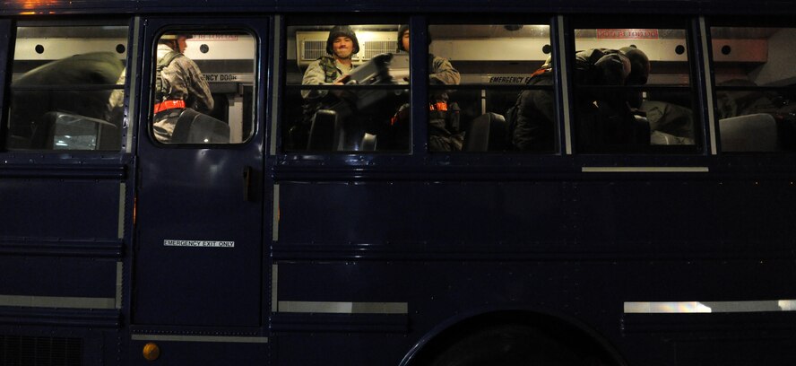 Airmen from the Hawaii Air National Guard work together to offload luggage from a bus before processing through a personnel deployment function line Nov. 7 during an exercise at Joint Base Pearl Harbor-Hickam, Hawaii. The PDF line tests the ability of Airmen to be medically, legally, administratively, spiritually, and financially ready to deploy, as well as the functionality of the processes in place with which to deploy them. (U.S. Air Force photo by Staff Sgt. Nathan Allen)