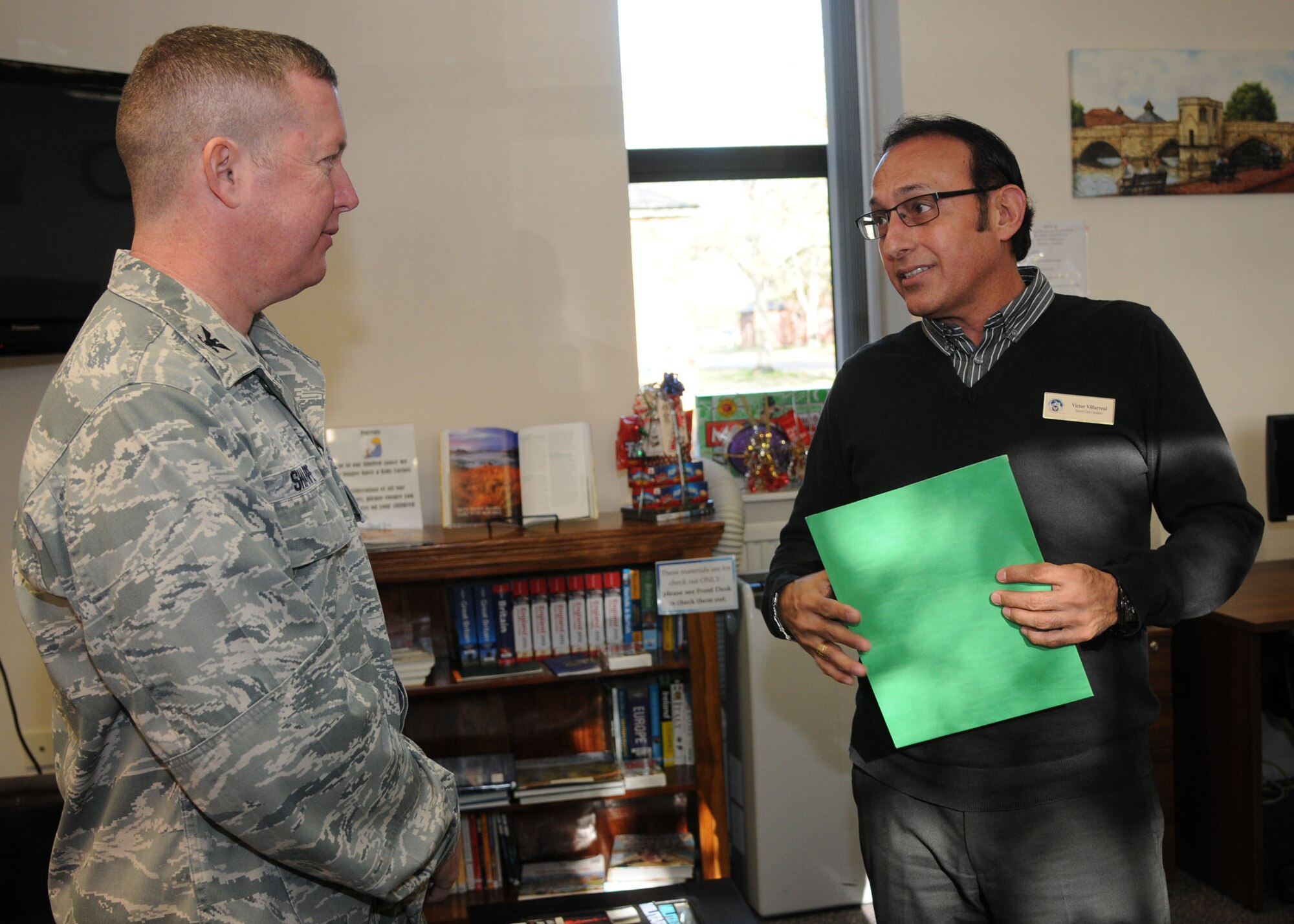 Victor Villarreal, 100th Force Support Squadron Discovery Center coordinator, speaks to Col. Christopher Sharpe, United States Air Forces in Europe director, manpower, personnel, and services, about the Discovery Center in the Airman and Family Readiness Center Nov.7, 2012, on RAF Mildenhall, England. Sharpe also visited RAF Lakenheath and RAF Alconbury. (U.S. Air Force photo by Airman 1st Class Kelsey Waters/Released)