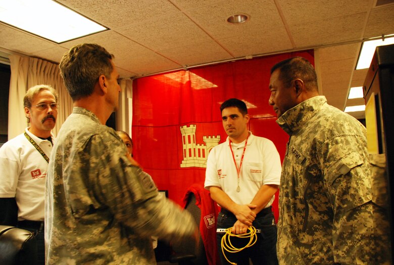 Lt. Gen. Thomas P. Bostick, U.S. Army Chief of Engineers and Commanding General of the U.S. Army Corps of Engineers (far right), visits with Don Ayres, a member of the Logistics Prepared Readiness Team from the St. Louis District (far left), Nov 3 at the North Atlantic Division Headquarters.