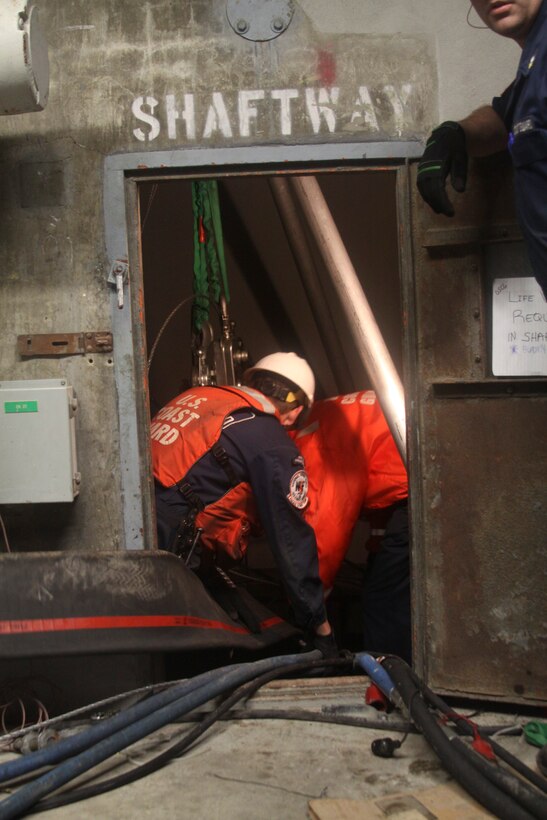 Coast Guardsmen with the Deployable Operations Group hook up additional pumps at the Brooklyn Battery Tunnel ventilation facility on Governor’s Island. The groups is assisting with the dewatering efforts in New York after hurricane Sandy.