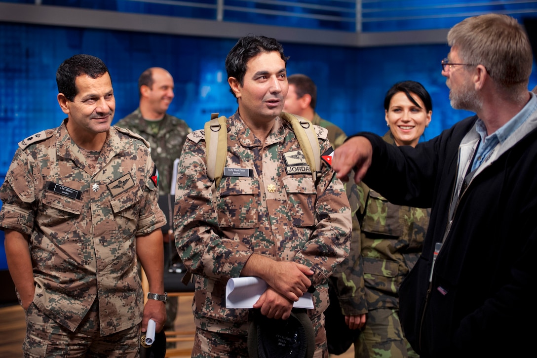 Roland Smith, right, Defense Media Activity production support specialist, introduces Jordanian students, Maj. Saleh Banifares, right, and Lt. Col. Saleh Alhlalat, left, to DMA's studio for media training on Fort Meade, Md., Nov. 2, 2012.