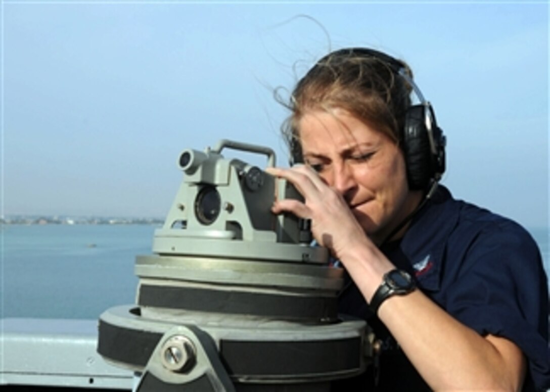 U.S. Navy Petty Officer 2nd Class Amy Etie uses an alidade to take a bearing reading from the bridge of the amphibious transport dock ship USS New York (LPD 21) as the ship transits the Suez Canal on Nov. 5, 2012.  The New York is part of the Iwo Jima Amphibious Ready Group and is deployed in support of maritime security operations and theater security cooperation efforts in the U.S. 5th Fleet area of responsibility.  