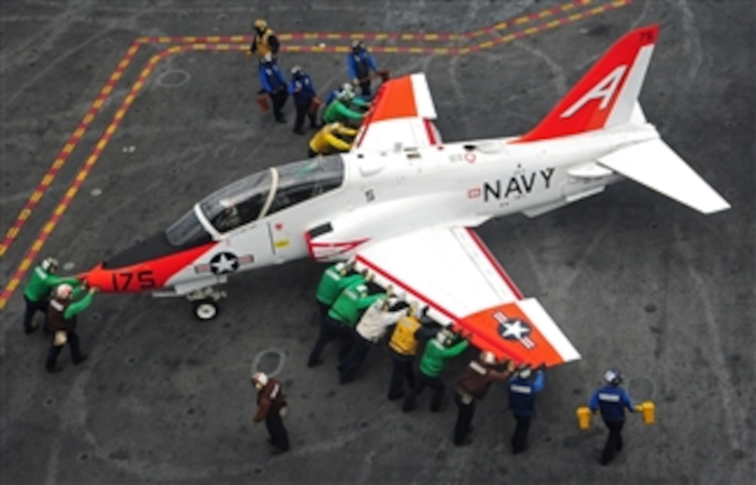 Flight deck crewmen push back a T-45C Goshawk to its spot on the flight deck of the aircraft carrier USS Harry S. Truman (CVN 75) as the ship operates in the Atlantic Ocean on Nov. 6, 2012.  The Truman is underway to conduct carrier qualifications for new pilots.  The Goshawk is attached to Training Squadron 7.  
