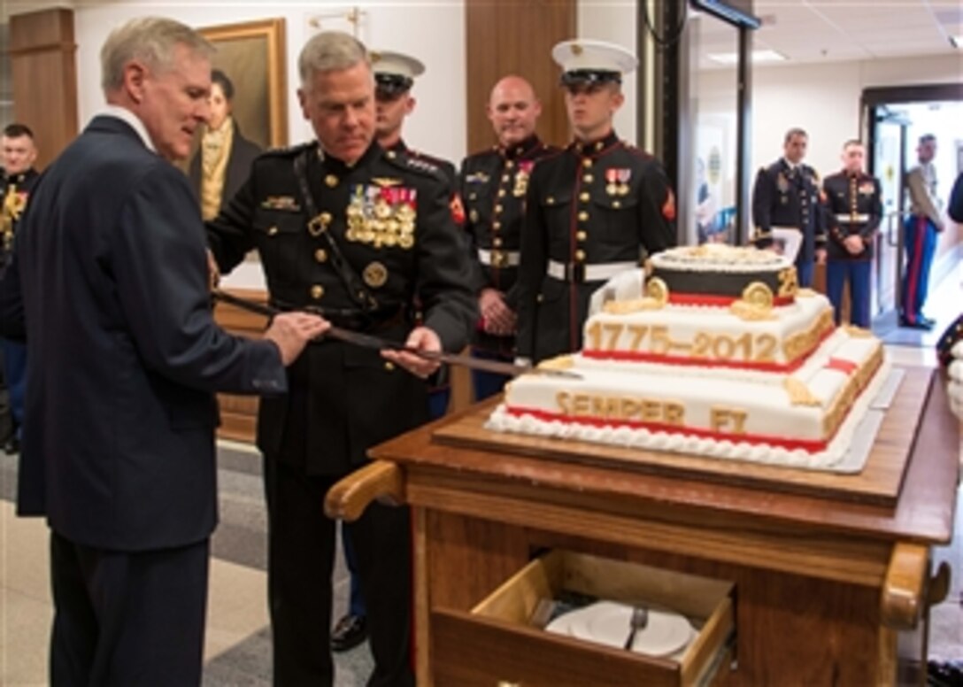 Secretary of the Navy Ray Mabus, left, and Commandant of the Marine Corps Gen. James F. Amos, second from left, use a sword to cut the cake at the Marine Corps birthday celebration in the Pentagon on Nov. 7, 2012