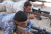 An American and Jordanian sniper lie side-by-side and sight in down their scopes at their respective targets, May 8. This class was apart of the combined training between the 77th Jordanian Reconnaissance battalion and the 24th Marine Expeditionary Unit’s Maritime Raid Force, 2nd Reconnaissance battalion during exercise Eager Lion 2012.