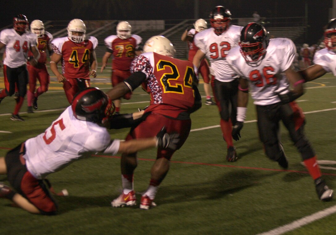 Players with the Marine Corps Air Station Miramar Falcons tackle a player with the 11th Marine Regiment Cannon Cockers during a playoff game against the Cannon Cockers at the Paige Field House football field aboard Marine Corps Base Camp Pendleton, Calif., Nov. 6. The Falcons’ next game is Nov. 20. 