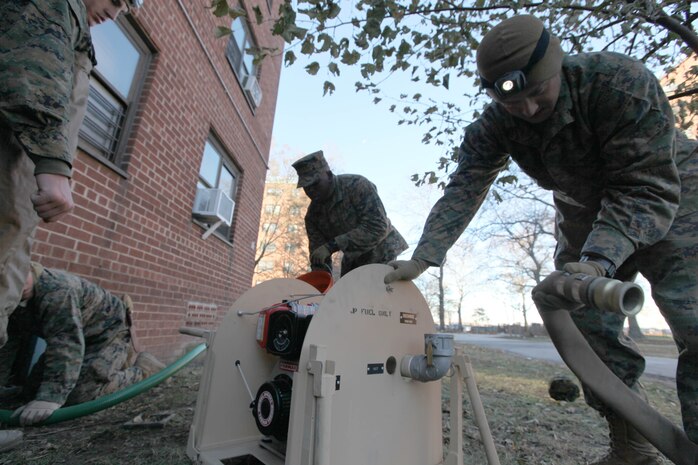 Marines with 8th Engineer Support Battalion, 2nd Marine Logistics Group hook hoses up to a pump in order to extract water from a flooded basement of a building while conducting humanitarian operations in Far Rockaway, N.Y., Nov. 4. In coordination with United States Northern Command, approximately 86 Marines with 8th ESB, 2nd MLG were deployed to New York to help with relief after Hurricane Sandy by pumping water out of flooded buildings.