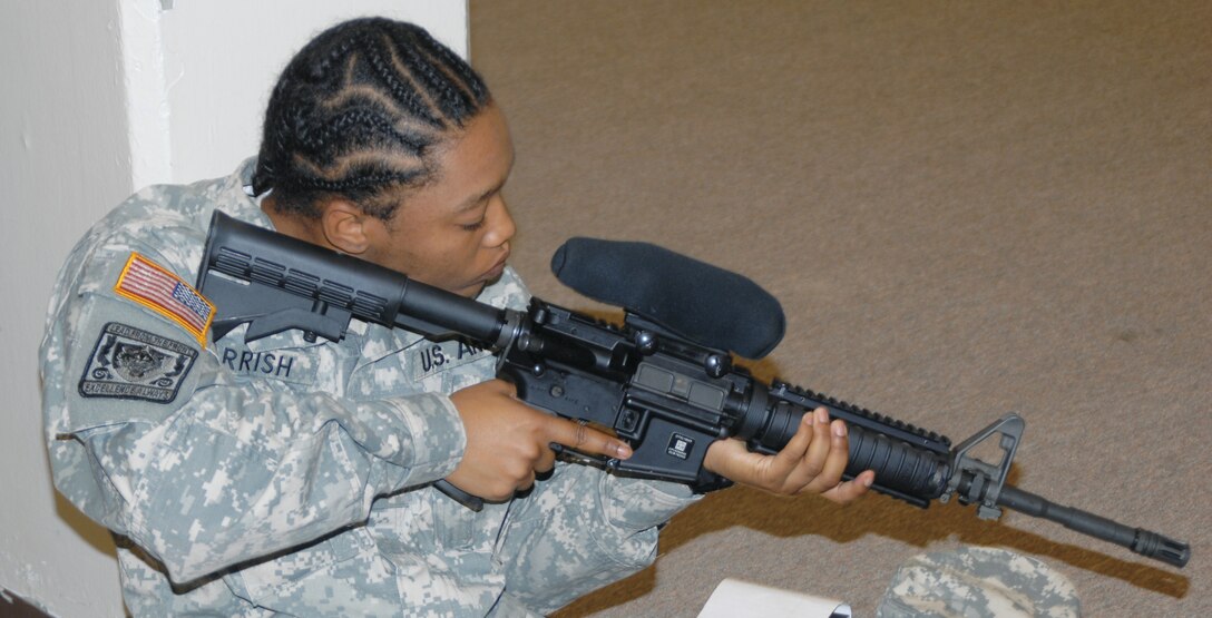Krystal Parrish, Army Reserve Officers Training Corps cadet, Albany State University, checks her sight alignment on the M4 rifle at Building 7120, here, Nov. 1.