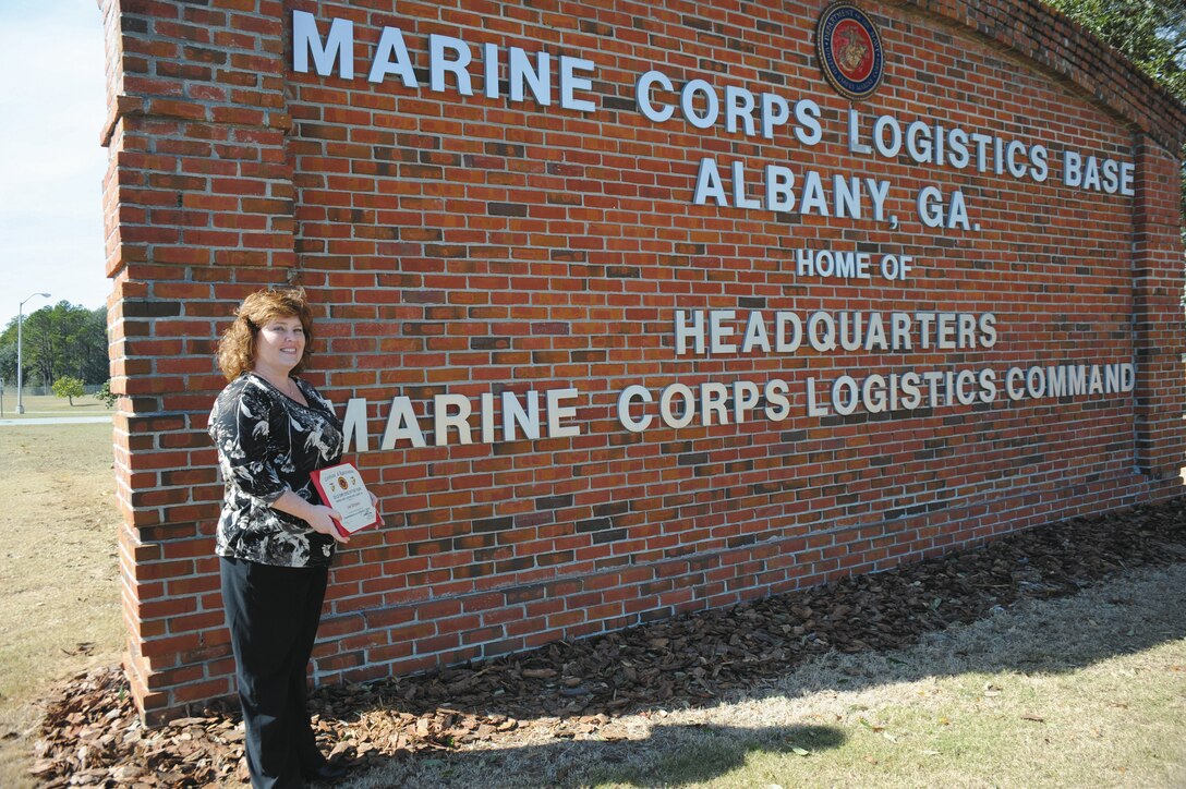 Lisa Simpson, program analyst, Operations and Training Division, Marine Corps Logistics Base Albany, displays the base’s 2012 Employee of the Year Award she received recently.