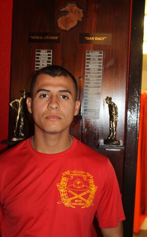 Sgt. Juan E. Duque, senior drill instructor, Platoon 1041, Company C, stands next to a plaque for their company’s Moral Leader and Dan Daly Award aboard Marine Corps Recruit Depot San Diego, Nov. 2. Duque is Co. C’s most recent recipient of the Moral Leader Award. Duque has helped train eight cycles of recruits.