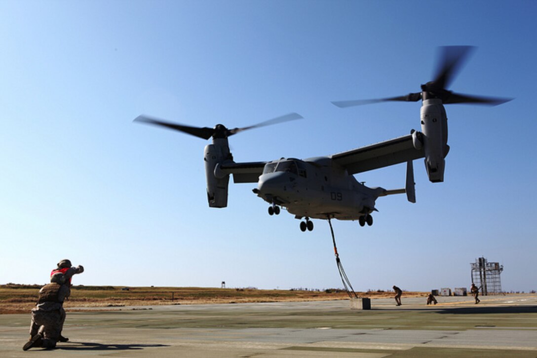 An MV-22B Osprey takes off after landing support specialists attached a 7,000-pound concrete block during dual-point external training on Ie Shima Oct. 25. Marine Medium Tiltrotor Squadron 265 recently switched from the CH-46E Sea Knight helicopter to the Osprey, which allows for dual-point external operations at faster speeds. The landing support specialists are with Combat Logistics Regiment 37, 3rd Marine Logistics Group, III Marine Expeditionary Force. The pilot and crew are with VMM-265, 1st Marine Aircraft Wing, III MEF