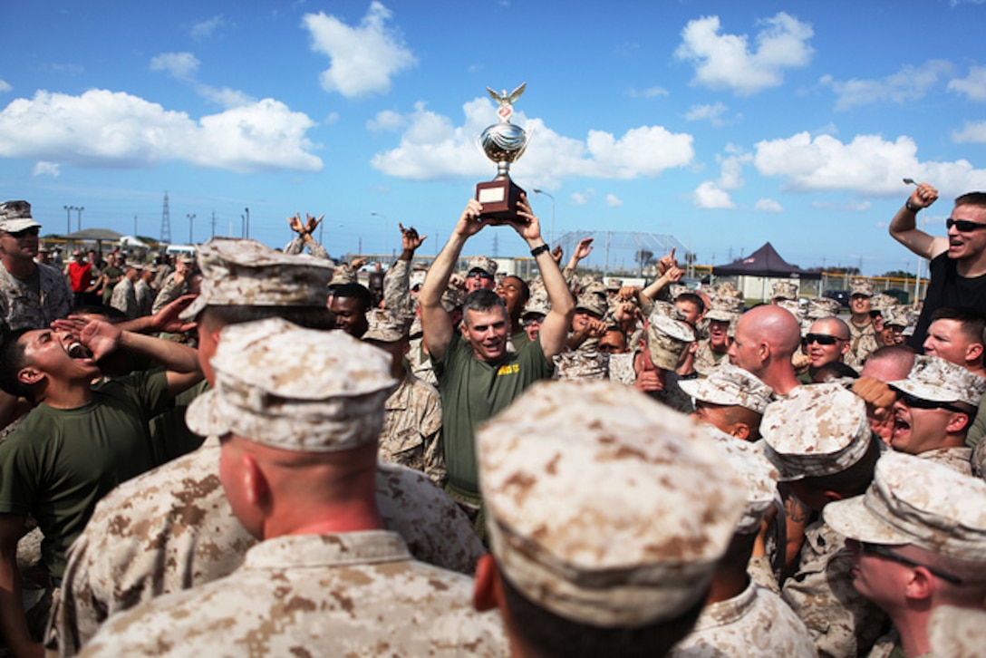 Lt. Col. Darin J. Clarke holds up the championship trophy at the 2nd annual super squadron competition at Marine Corps Air Station Futenma Oct. 26. Clarke’s unit, Marine Wing Support Squadron 172, earned the most points throughout 10 rigorous events to claim first place. Clarke is the commanding officer of MWSS-172
