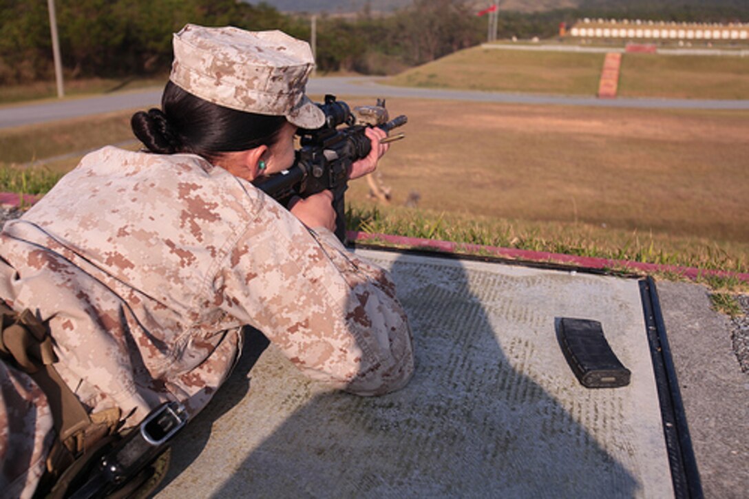 Lance Cpl. Jessica Coleman fires an M4 rifle during combat marksmanship training at Camp Hansen Oct. 29. Coleman is a motor vehicle operator with Combat Logistics Battalion 4, Combat Logistics Regiment 35, 3rd Marine Logistics Group.