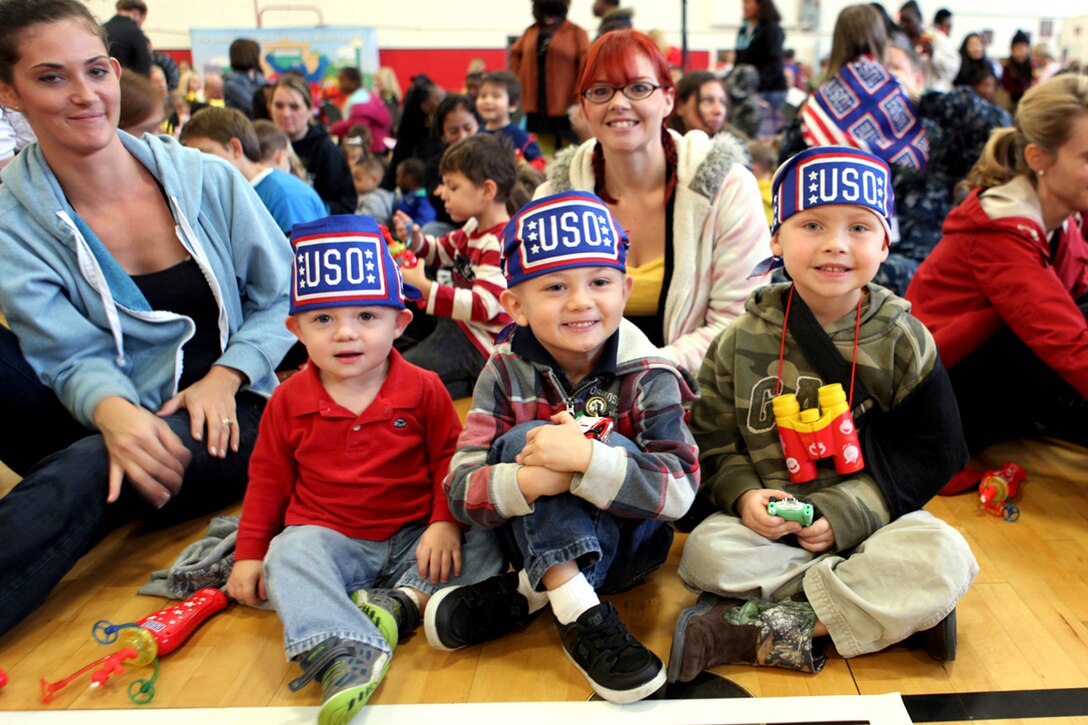 Jonah Miller and brother Simon, along with Wyatt Lemmons, whose fathers are drill instructors at Marine Corps Recruit Depot Parris Island, enjoy the Sesame Street/ USO Experience for Military Families aboard the Air Station Fitness Center, Nov. 6. The exclusive live performance feautured characters from Sesame Street to help children relate and cope with the challenges that coincide military lifestyle.