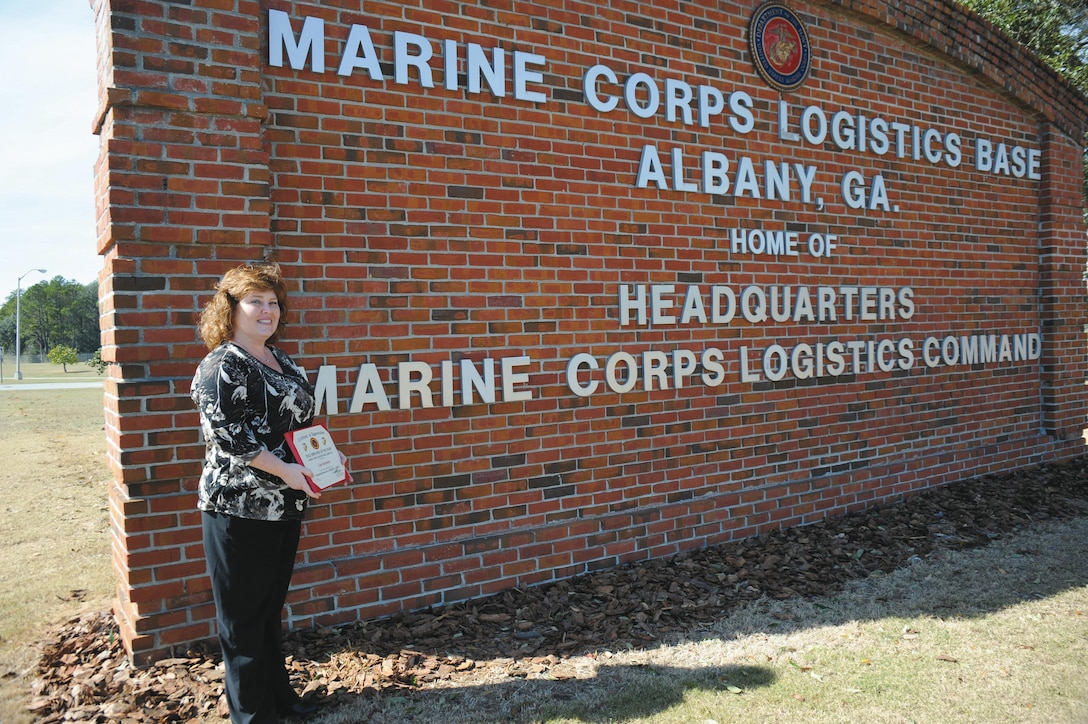 Lisa Simpson, program analyst, Operations and Training Division, Marine Corps Logistics Base Albany, displays the base's 2012 Employee of the Year Award she received recently.